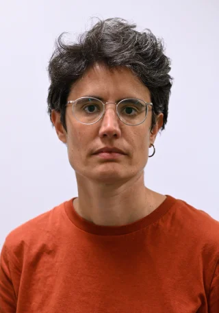Woman with glasses looking at camera