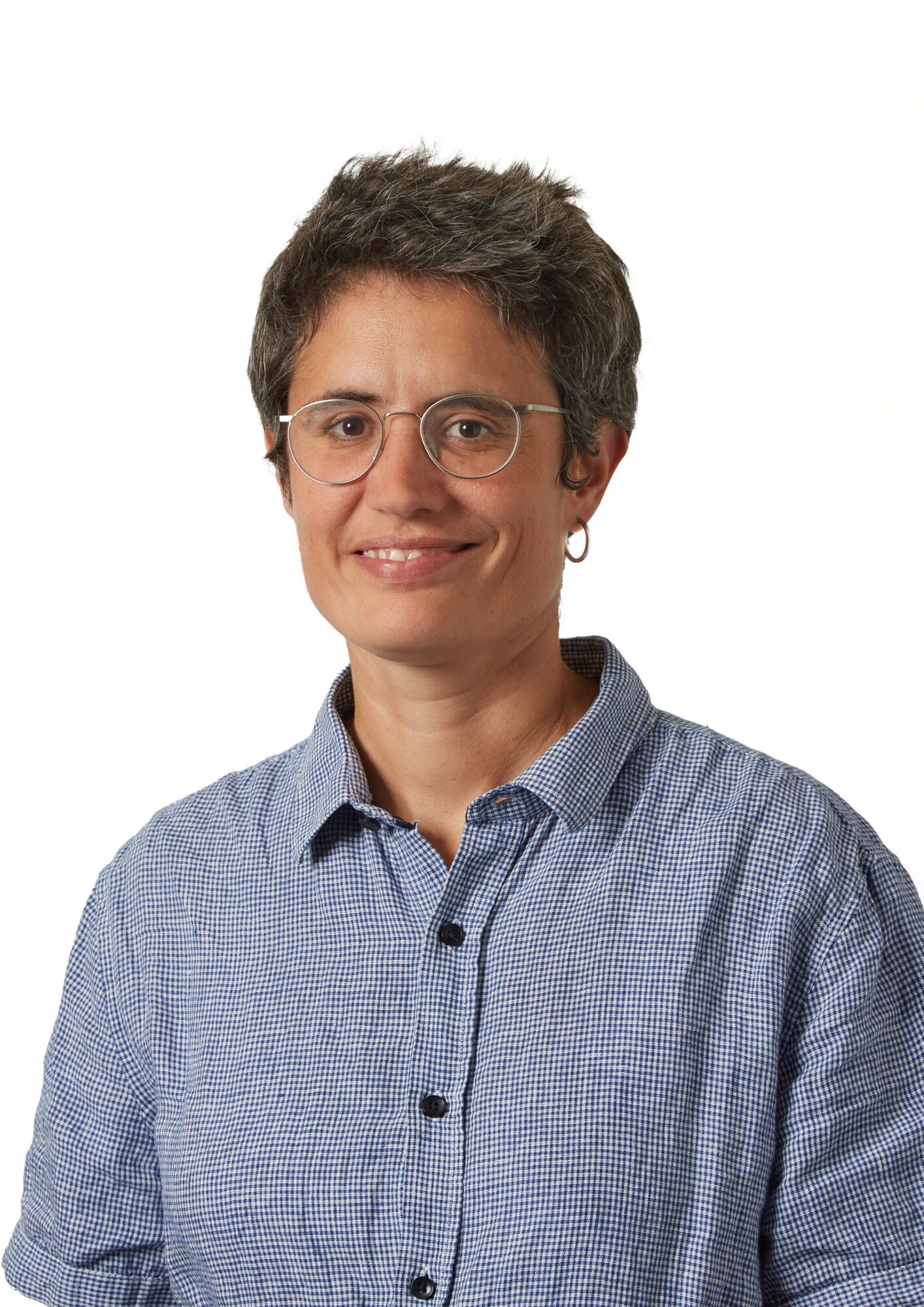 Woman with glasses smiling at camera