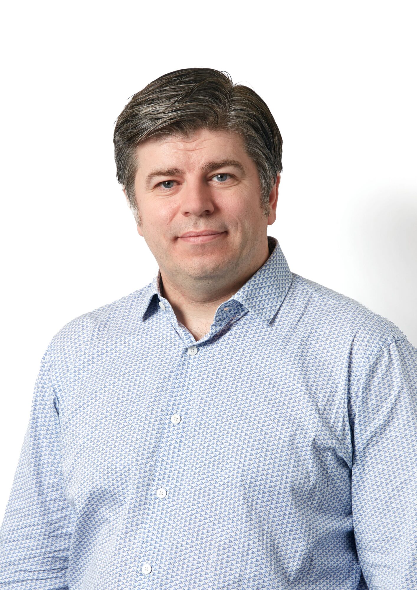 Man in shirt smiling at camera