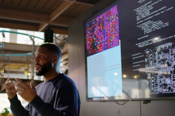 man in front of presentation screen