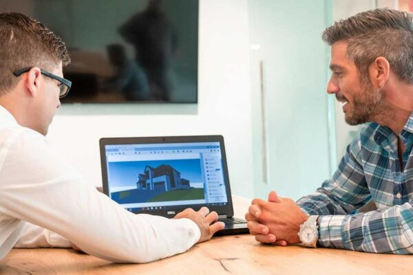 2 people looking at laptop screen
