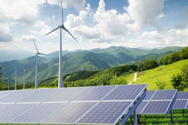 Solar panels and wind turbines in UK countryside