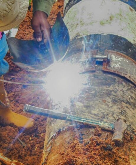 Workers fixing underground pipes