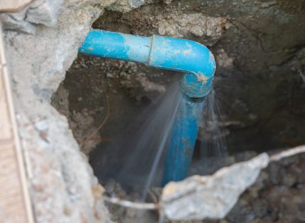 Blue pipe leaking water