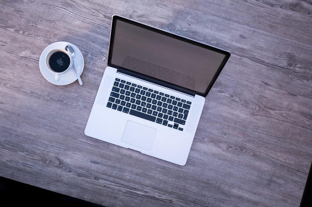 Laptop and cup of coffee on a desk