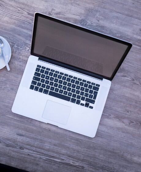 Laptop and cup of coffee on a desk