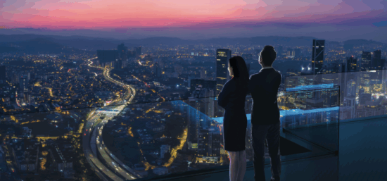 Two people looking over city skyline