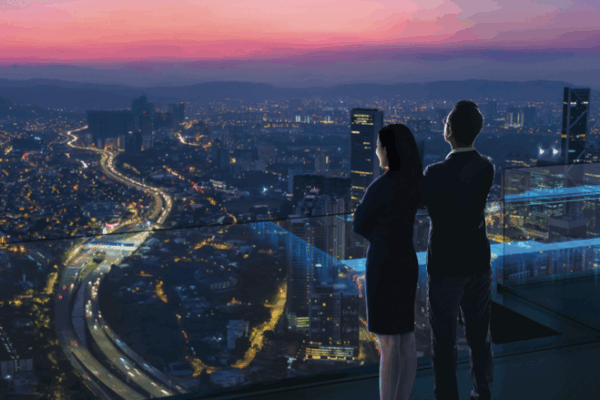 Two people looking over city skyline