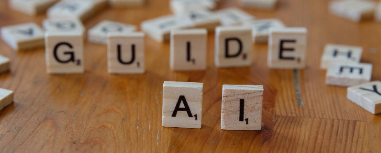 Scrabble tiles spelling GUIDE AI