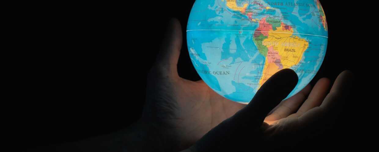 Hands holding a glowing globe