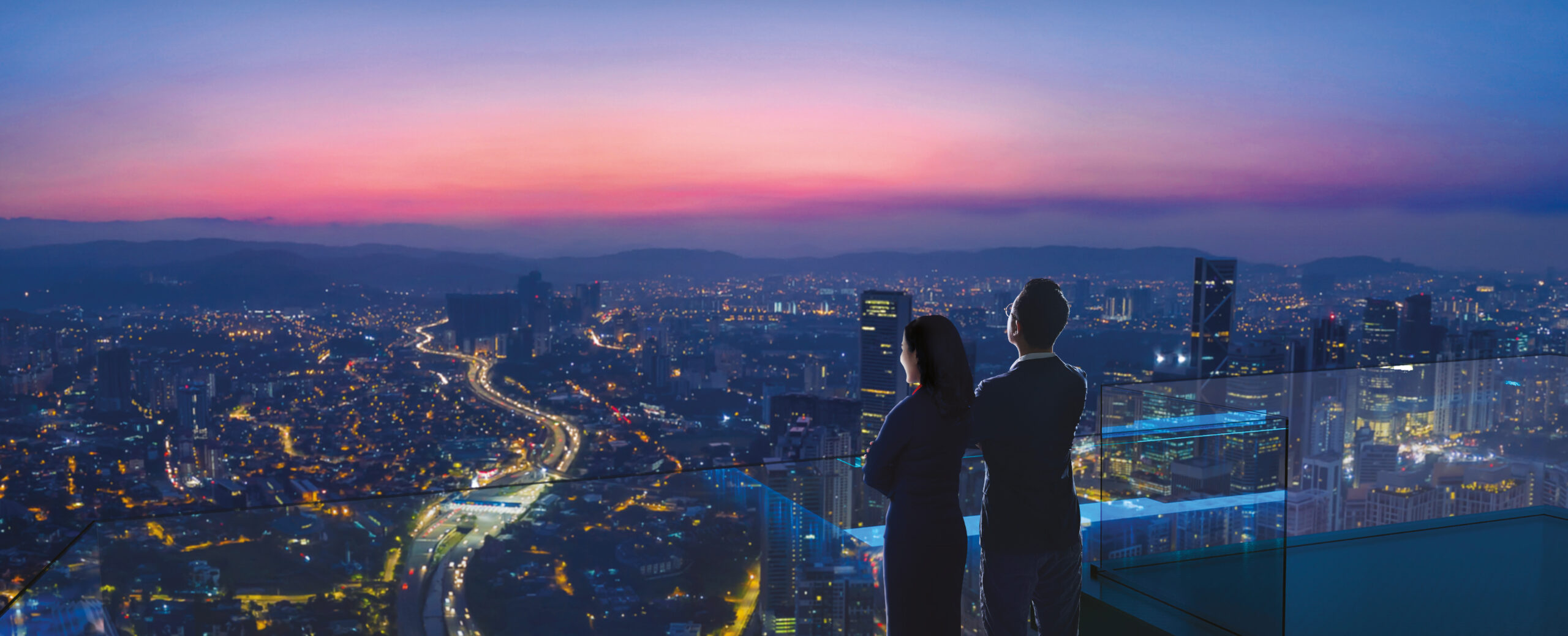Man and woman overlooking London city at night